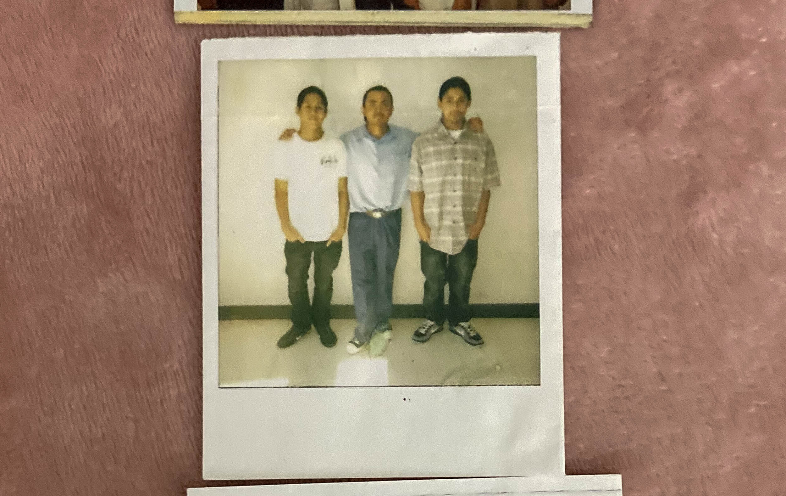 Polaroid photo of three young men.